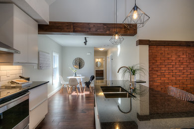 Small medium tone wood floor kitchen/dining room combo photo in Toronto with gray walls