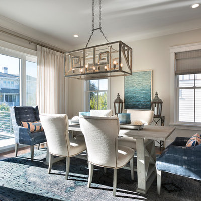 Example of a beach style medium tone wood floor and brown floor dining room design in Charleston with beige walls