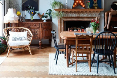 Photo of a medium sized eclectic dining room in London with light hardwood flooring and brown floors.