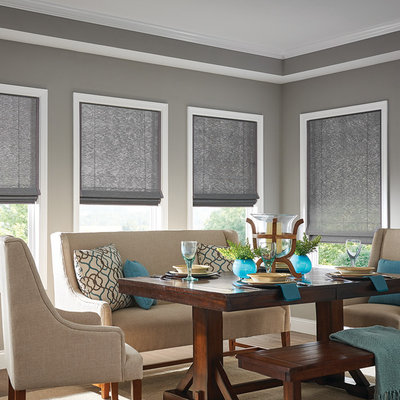 Mid-sized elegant medium tone wood floor and brown floor enclosed dining room photo in Chicago with gray walls and no fireplace