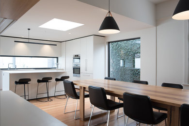 Photo of a contemporary dining room in Hobart with white walls.