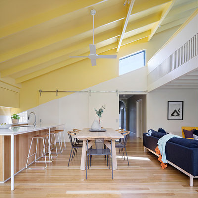 Inspiration for a contemporary medium tone wood floor and brown floor great room remodel in Geelong with white walls