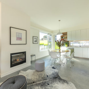 This is an example of a small contemporary open plan dining in Canberra - Queanbeyan with concrete floors and grey floor.