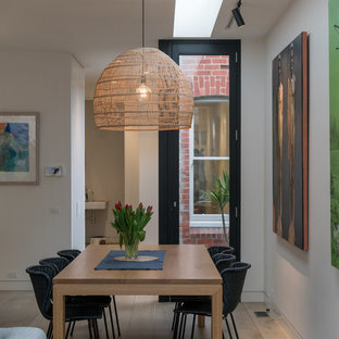 Inspiration for a contemporary open plan dining in Melbourne with white walls, medium hardwood floors and brown floor.