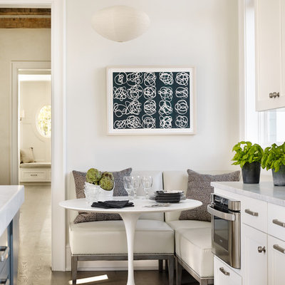 Example of a beach style medium tone wood floor dining room design in Atlanta with white walls