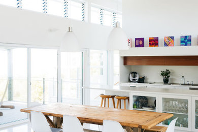 Inspiration for a contemporary beige floor and wood ceiling great room remodel in Wollongong with white walls