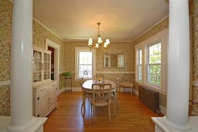 Large contemporary kitchen/dining room in Boston with multi-coloured walls, medium hardwood flooring and no fireplace.