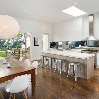 Large trendy dark wood floor great room photo in Melbourne with white walls and no fireplace