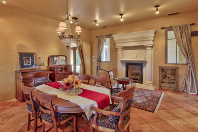 Inspiration for a large eclectic porcelain tile and multicolored floor enclosed dining room remodel in Albuquerque with beige walls, a standard fireplace and a plaster fireplace