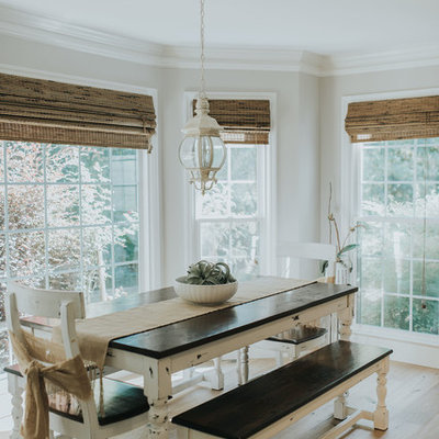 Example of a beach style medium tone wood floor and brown floor dining room design in Atlanta with beige walls