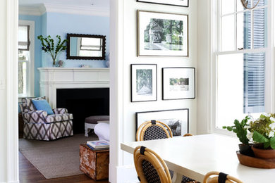 Inspiration for an eclectic medium tone wood floor enclosed dining room remodel in DC Metro with white walls