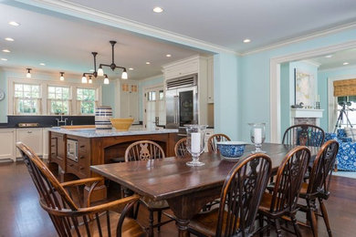 Large dark wood floor kitchen/dining room combo photo in Boston with blue walls