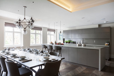 Photo of a large contemporary kitchen/dining room in London with dark hardwood flooring.