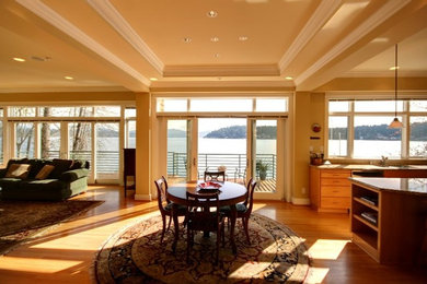 Large beach style open plan dining room in Seattle with beige walls and light hardwood flooring.