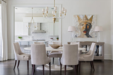 Medium sized traditional dining room in New Orleans with white walls, dark hardwood flooring and feature lighting.