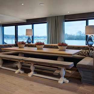 Contemporary dining room in Gloucestershire with grey walls, light hardwood flooring and beige floors.
