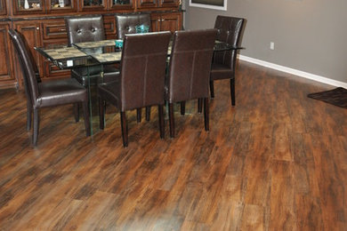 Large elegant medium tone wood floor and brown floor great room photo in Other with gray walls and no fireplace
