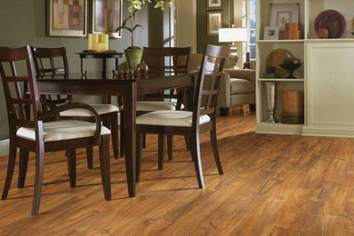 Inspiration for a contemporary medium tone wood floor and brown floor dining room remodel in Boston with gray walls