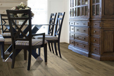 Example of a classic laminate floor and brown floor dining room design in Houston