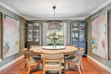 Medium sized contemporary enclosed dining room in Orlando with grey walls and medium hardwood flooring.