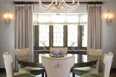 This is an example of a medium sized classic enclosed dining room in New York with grey walls, dark hardwood flooring, no fireplace and brown floors.