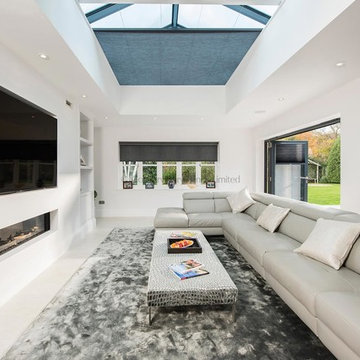 Large open plan TV room and dining room with large glass lantern roof with solar