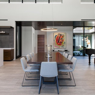 Example of a large minimalist porcelain tile and gray floor great room design in Las Vegas with white walls and no fireplace