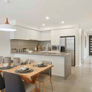Design ideas for a contemporary open plan dining in Sydney with no fireplace, white walls and beige floor.
