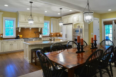 Elegant medium tone wood floor dining room photo in Minneapolis with beige walls