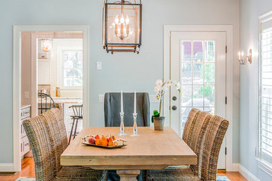 Example of a mid-sized transitional medium tone wood floor enclosed dining room design in Boston with blue walls and no fireplace