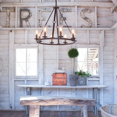 Great room - large country medium tone wood floor great room idea in Austin with white walls and no fireplace