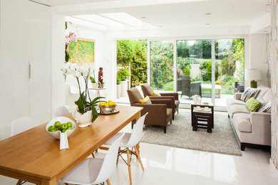 Medium sized contemporary dining room in Cambridgeshire with white walls and porcelain flooring.