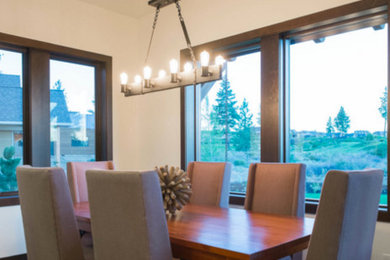 Mid-sized trendy medium tone wood floor enclosed dining room photo in Portland with white walls and no fireplace