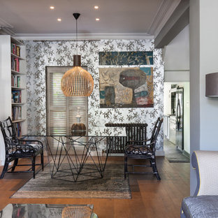 This is an example of a small bohemian dining room in London with brown floors.