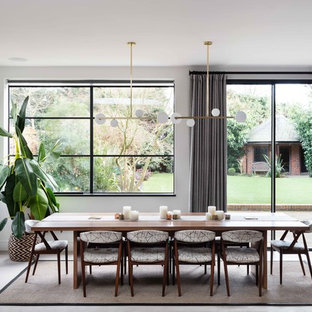 Design ideas for a contemporary dining room in London with grey walls and grey floors.