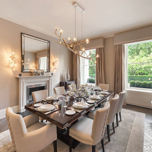 Medium sized classic dining room in Other with beige walls, dark hardwood flooring and a standard fireplace.