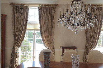 Large elegant enclosed dining room photo in New York with beige walls