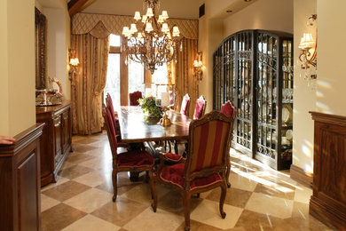 Example of a large classic beige floor and travertine floor enclosed dining room design in Los Angeles with beige walls