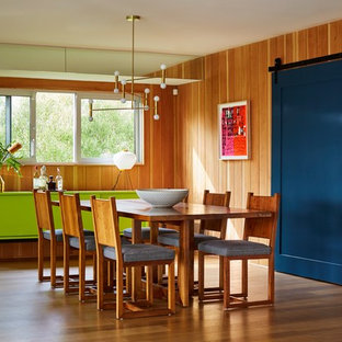 Inspiration for a 1950s medium tone wood floor dining room remodel in Los Angeles with orange walls and no fireplace