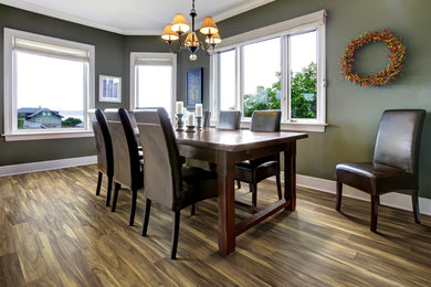 Inspiration for a mid-sized timeless laminate floor and brown floor enclosed dining room remodel in Charleston with green walls and no fireplace