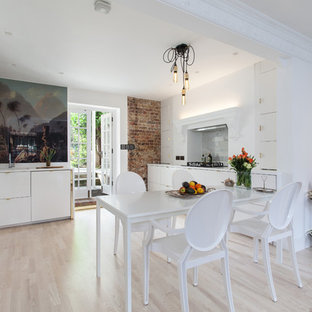 Design ideas for a medium sized contemporary dining room in London with white walls and light hardwood flooring.