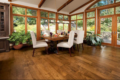 Inspiration for a mid-sized craftsman medium tone wood floor great room remodel in Kansas City with white walls and no fireplace