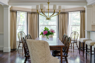 Example of a mid-sized transitional dark wood floor and brown floor kitchen/dining room combo design in Burlington with white walls