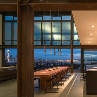 Inspiration for an industrial concrete floor and gray floor great room remodel in Seattle with beige walls