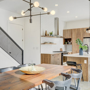 Esempio di una sala da pranzo aperta verso la cucina industriale con pareti bianche, pavimento in cemento e pavimento grigio