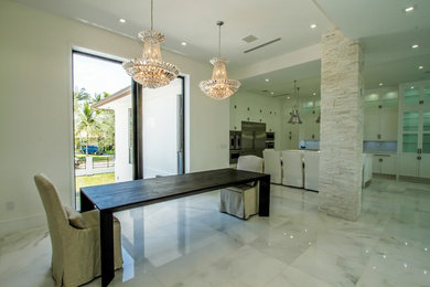 Large modern open plan dining room in Miami with white walls, marble flooring, no fireplace and white floors.