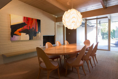 Inspiration for a 1960s dining room remodel in Other with beige walls, a standard fireplace and a brick fireplace