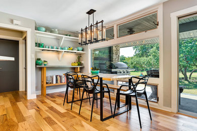 Great room - mid-sized transitional light wood floor great room idea in Austin with gray walls and no fireplace