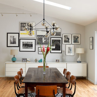 Example of a 1950s light wood floor dining room design in Los Angeles with gray walls