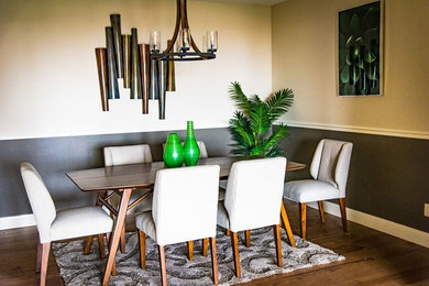 Example of a mid-sized trendy medium tone wood floor and brown floor enclosed dining room design in Portland with multicolored walls and no fireplace